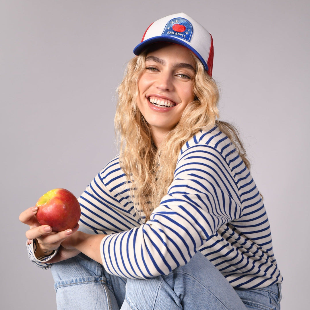 Sand and Camels, Bad Apple, fruit collection, trucker hat, cap, a smiling woman, product
