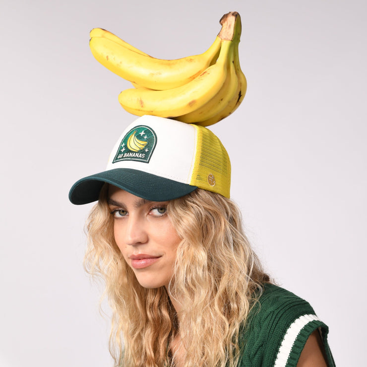 sand and camels cap, go bananans, A woman with bananas on her head